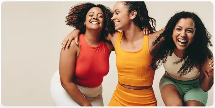 Three women laughing together after a Restore Your Core session