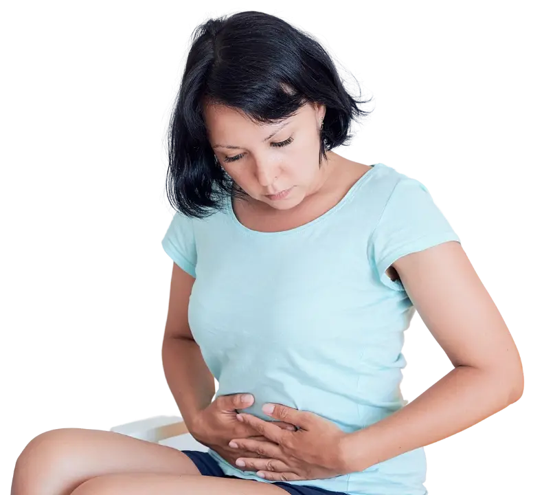A woman sitting with both hands resting on her lower belly