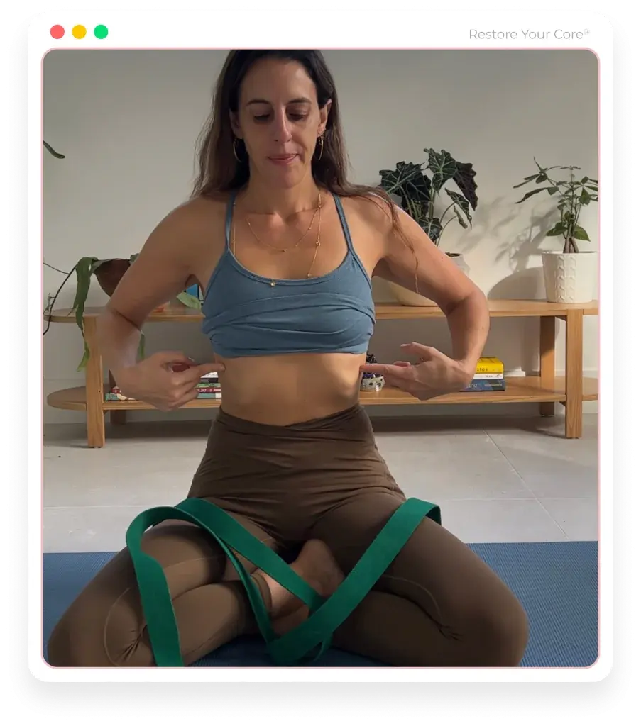 Lauren Ohayon seated on a mat, framing her ribs with both hands during an RYC® exercise