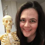 Shayne Henderson, holding a small-scale skeleton model