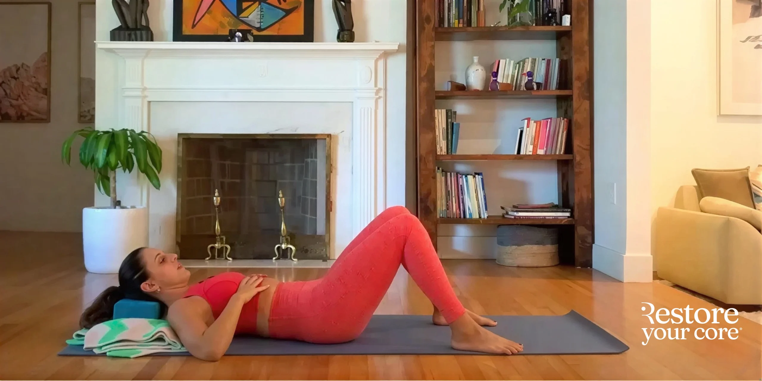 Lauren Ohayon, laying face up on a yoga mat, demonstrating correct breathing technique for pelvic floor